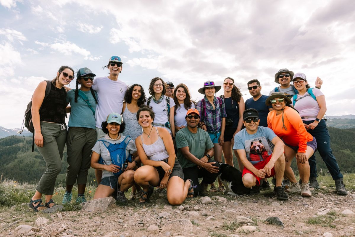 A group of hikers convene for a photo.