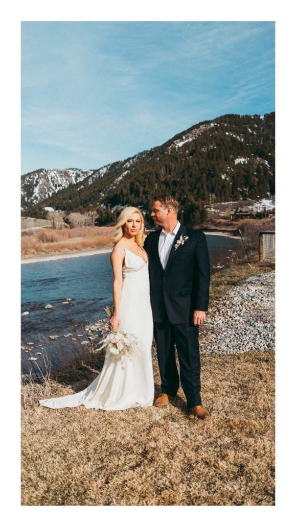 A bride and groom stand next to the Snake River at Astoria Hot Springs.
