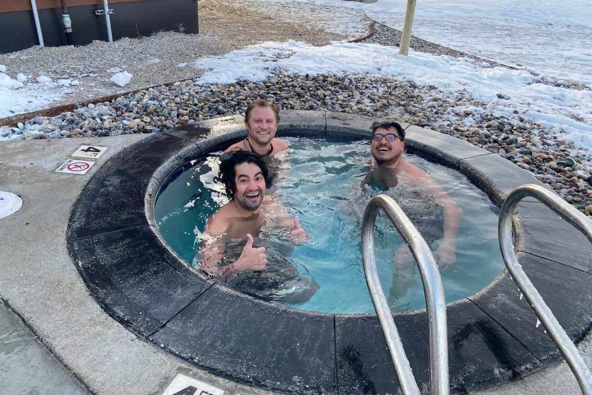 Three men dip in the cold plunge pool at Astoria Hot Springs.